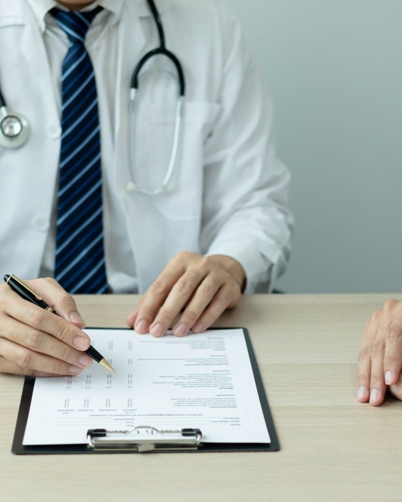 Man doctors explain and recommend treatment after a female patient meets a doctor and receives results regarding illness problems. Medical and health care concepts.